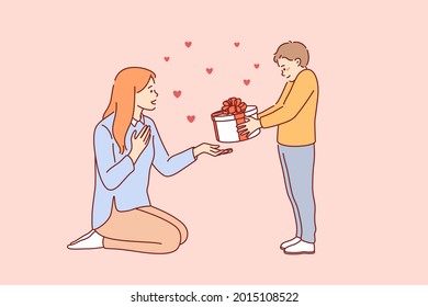 Celebrating Happy Mothers day concept. Small smiling boy cartoon character standing giving present box to his young mother for holiday vector illustration 