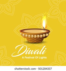 Celebration of Diwali with illuminated oil lit lamp and stylish text of Happy Diwali.