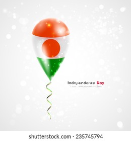 Celebration and gifts. Ribbon in the colors are twisted under the balloon. Independence Day. Balloons on the feast the national Flag of Niger