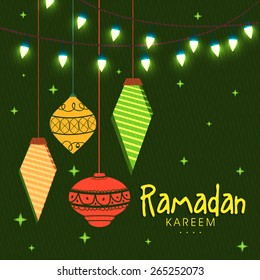 Celebrations for Islamic holy month of prayers, Ramadan Kareem with colourful decorative lanterns and lights on green background.