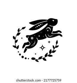 Celestial animal silhouette of jumping rabbit. Magic bunny with natural elements. Black magical bunny rabbit, mystic crescent moon esoteric symbol, constellation elements. Vector rabbit for decoration