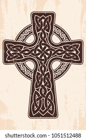 Celtic cross with national ornament as interlaced ribbon. Old brown background with the aging effect.