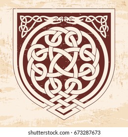 Celtic national ornament interlaced tape. Brown pattern with the aging effect on a beige background.