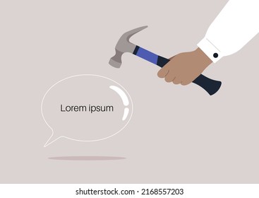A censorship concept, a hand smashing a speech bubble with a hammer