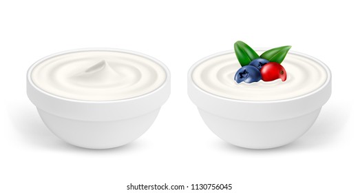 Ceramic bowls of white yogurt with berries isolated on white background