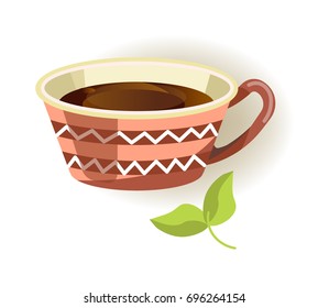 Ceramic cup with pattern and black tea inside