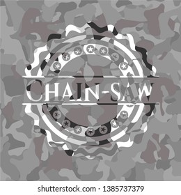 Chain-saw on grey camouflaged pattern