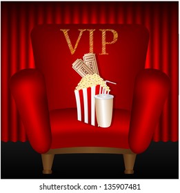 chair and popcorn and a drink on a background of red curtains