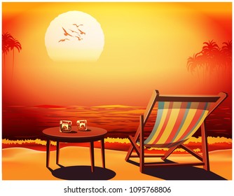 Chaise lounge, table and two glasses of whiskey on the seashore against the sunset