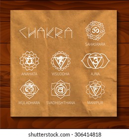 Chakra. Energy centers of the human. Texture wrapping paper on the background of wooden boards. The image can be used for your business as the logo