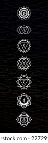 Chakra symbols on black background with colorful lines. Esoteric decoration for yoga and meditation practices. Vector illustration. 