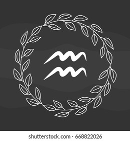 Chalk drawing flat aquarius symbol in rustic floral wreath