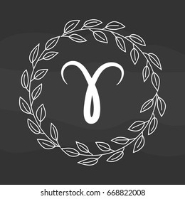 Chalk drawing flat aries symbol in rustic floral wreath