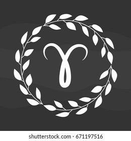 Chalk drawing flat aries symbol in rustic floral wreath