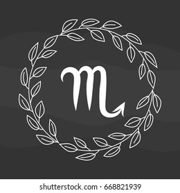 Chalk drawing flat scorpio symbol in rustic floral wreath