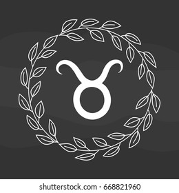 Chalk drawing flat taurus symbol in rustic floral wreath