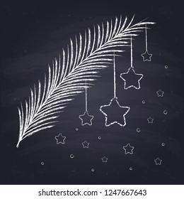 Chalk drawn spruce branch with stars on chalkboard background. New Year decoration.