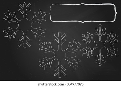 Chalk frame with snowflakes over black chalkboard for your Christmas text.