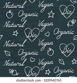 Chalkboard seamless pattern with hand drawn text - Organic, Natural, Bio, Vegan. Modern background with italic lettering on blackboard.
