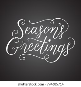 Chalkboard Season's Greetings Hand-lettered holiday message isolated on a dark grey chalkboard style background
