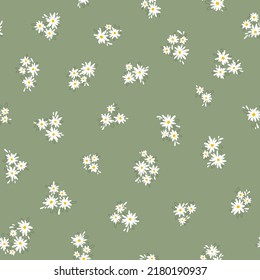 Chamomile floral mille fleur seamless pattern on green background. Small summer flowers in simple scandinavian cartoon doodle style perfect for textile, wallpaper, fabric