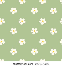 Chamomile floral seamless pattern on green background. Small summer flowers in simple cartoon doodle style perfect for textile, wallpaper, fabric.Vector illustration