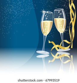 Champagne glasses on blue background with some golden ribbons - new year concept