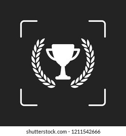 Champions cup with laurel wreath. Simple icon. White object in camera autofocus on dark background