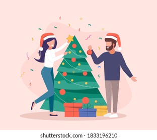 Characters decoration. Young beautiful couple decorate Christmas tree. Gifts under christmas tree.