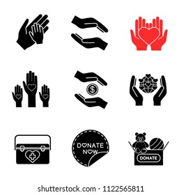 Charity glyph icons set. Silhouette symbols. Helping hands, donate now sticker, Earth saving, toys donation, organ transplant box, unity in diversity. Vector isolated illustration