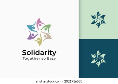 Charity or together logo in hand and sun represent peace or solidarity