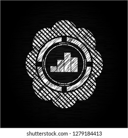 chart icon inside chalkboard emblem written on a blackboard