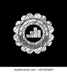 chart icon inside chalkboard emblem written on a blackboard