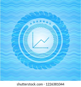 chart icon inside water wavec oncept emblem.