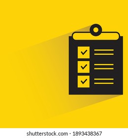 check list on clipboard with shadow on yellow background