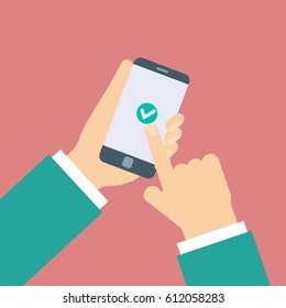 Check mark. Hands touching smart phone.