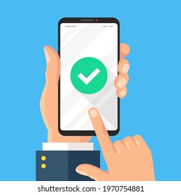 Check mark on smartphone screen. Hand holds mobile phone with green check mark icon. Modern flat design. Vector illustration