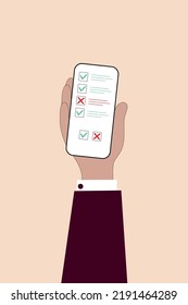 Check marks on mobile phone in business man hand, online survey, customer feedback, voting, choice, validation concept