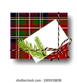 Checked tartan plaid gift present box with tied string bow and a fir tree branch and blank note with copy space. Wrapping diy idea. Vector illustration. Top view