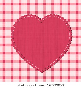 Checkered background with textile heart label