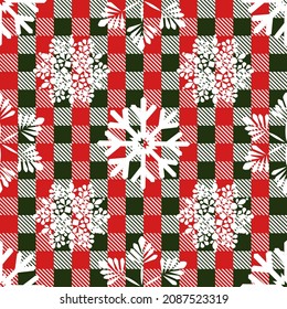 Checkered fabric in green and red with superimposed white snowflakes. Seamless festive pattern for modern textiles, wrapping paper. Vector.