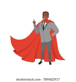 Cheerful afro-american business man standing with index finger up. Male character in suit, tie and red superhero mantle. Successful office worker. Flat vector design