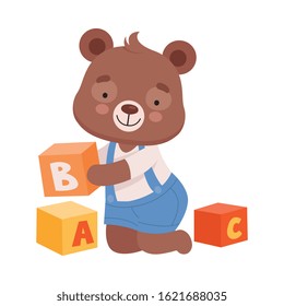 Cheerful Bear Character Wearing Playsuit Sitting on the Floor and Playing Alphabet Cubes Vector Illustration