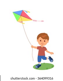 Cheerful boy enjoying flying kite. 