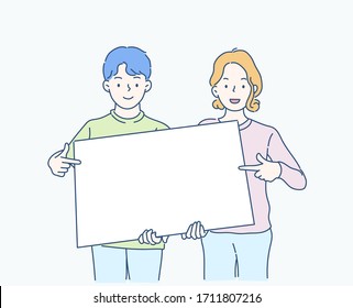 Cheerful boy and girl are holding the white blank banner and pointing down at a copy space. Hand drawn in thin line style, vector illustrations.