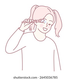 A cheerful child is playfully brushing her teeth with a colorful toothbrush, promoting good dental hygiene