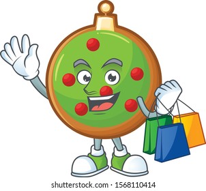 Cheerful christmas ball cartoon character waving and holding shopping bag.