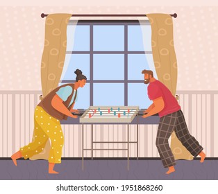 Cheerful couple with board game. Man and woman play table football together in room near stairs