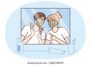 Cheerful couple with rejuvenating mask on faces look in mirror and laugh enjoying joint vacation. Morning young happy man and woman with mask for rejuvenation and removal of wrinkles from face