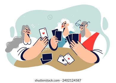 Cheerful elderly people play cards enjoying gambling entertainment in company of friends from nursing home or hospice. Happy old women and man playing cards having fun after retirement
